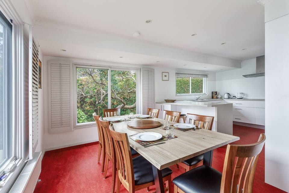 Share meals at the dining table for eight, where leafy garden vistas create a relaxed, natural atmosphere for every gathering.