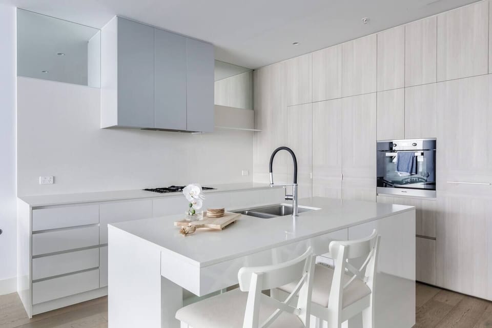 The kitchen’s island with stools offers a relaxed spot to enjoy morning coffee or casual meals.