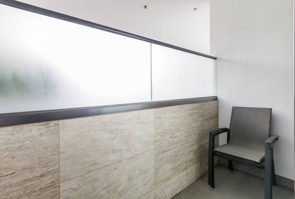A private balcony off the second bedroom offers a peaceful nook to read or enjoy morning coffee.