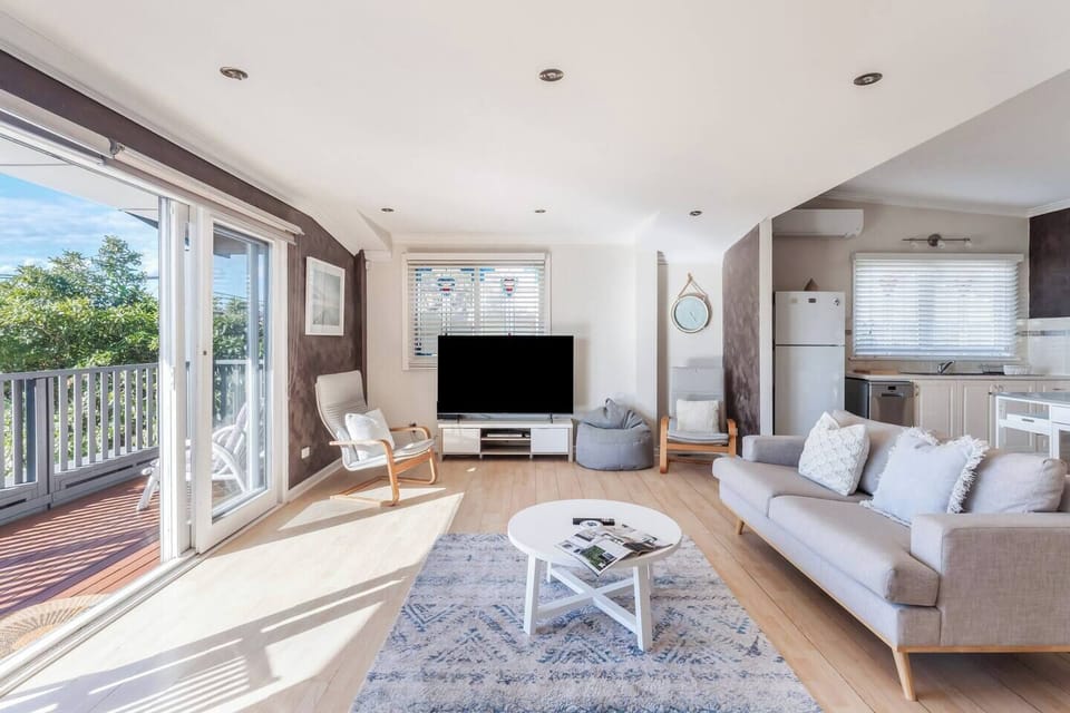 Slide open the doors from the living area and step onto the front deck, where elevated outlooks and breezy outdoor seating invite quiet moments with a coffee or evening drink in the fresh coastal air.