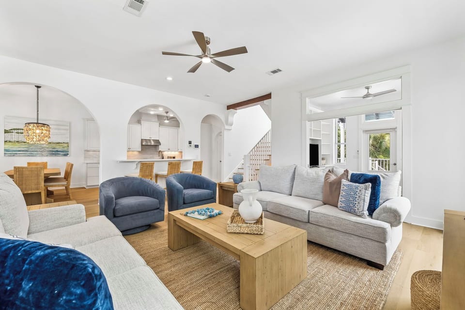 Step into your coastal retreat where high ceilings and elegant archways create an airy flow between your spacious living area, dining space, and gourmet kitchen—perfect for relaxing or gathering with loved ones.
