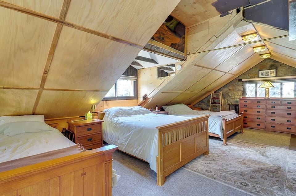 Bedroom with end table dressers, twin, full and queen beds shown.