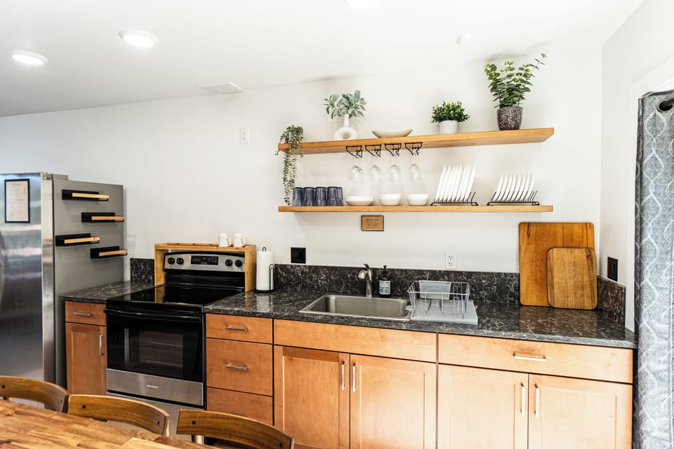 Bright modern kitchen with open shelving and full-size appliances
