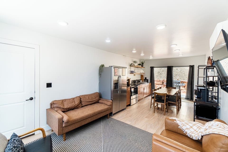 Bright open living space with full kitchen and easy patio access