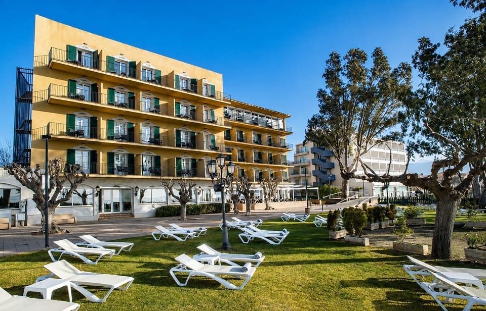 Hotel building with Mediterranean landscaping.