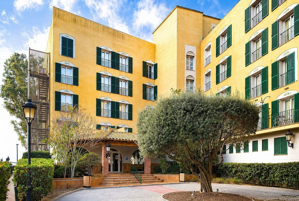 Hotel building and outdoor terrace area.