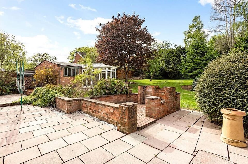 Rear patio & garden with double barbecue cooking area.