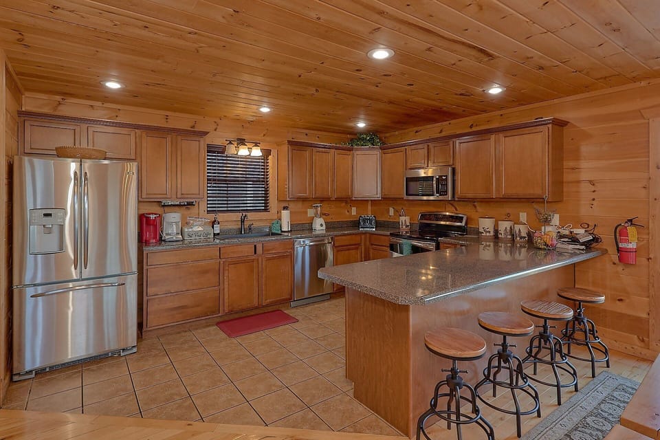 Full Kitchen with bar seating in 5 bedroom cabin