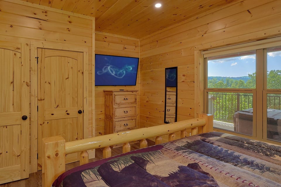 Cabin bedroom with TV and private bathroom