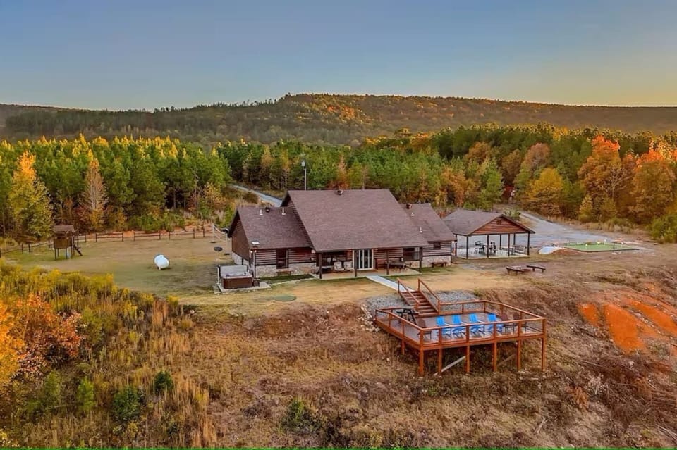 Full aerial perspective of the cabin, decks, and outdoor amenities on 12 secluded acres.