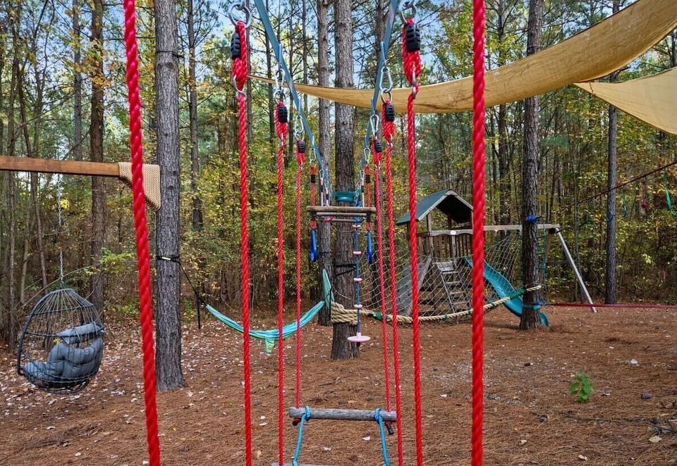 Private forest playground with hammock, slide, and adventure course