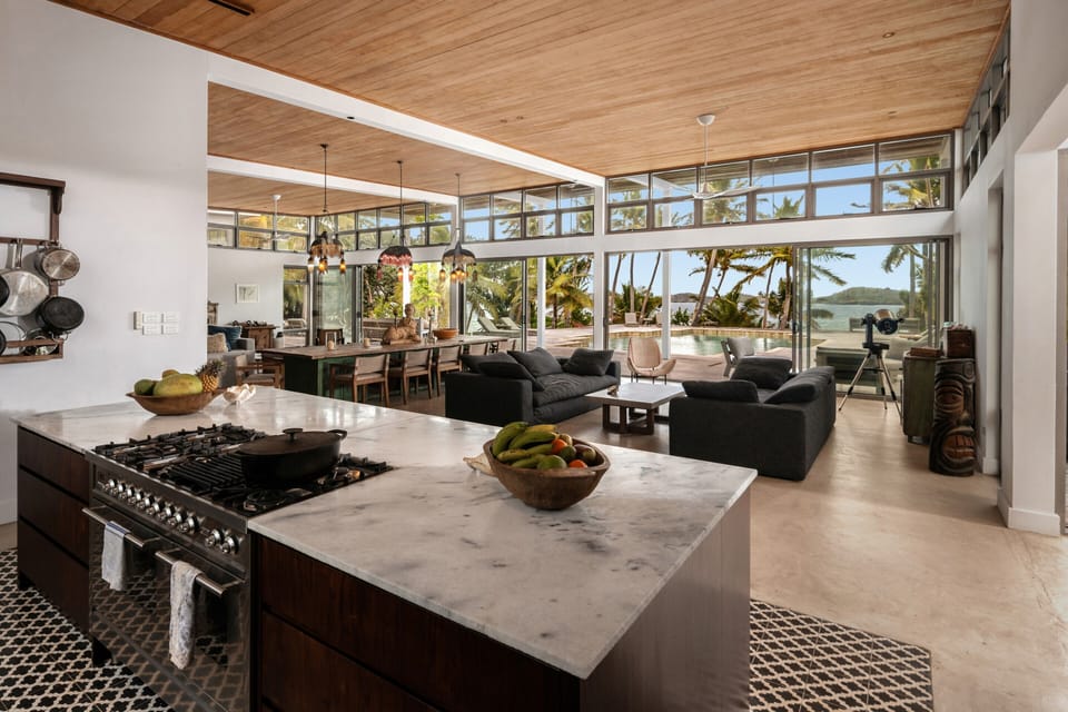 Open-concept luxury living with chef’s kitchen and tropical views