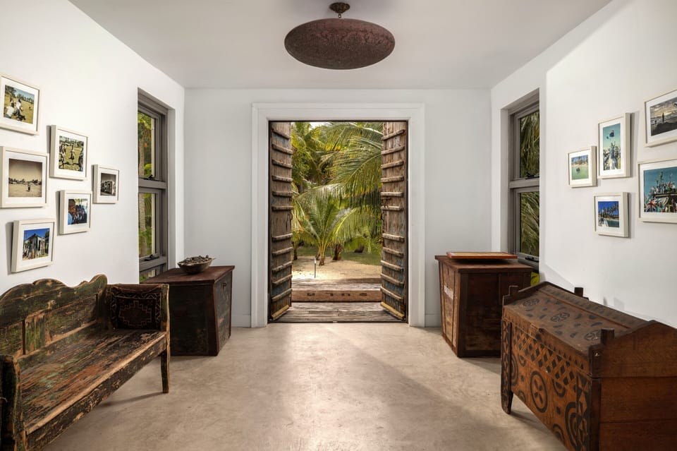 Welcoming tropical entryway with rustic decor and beautiful garden views