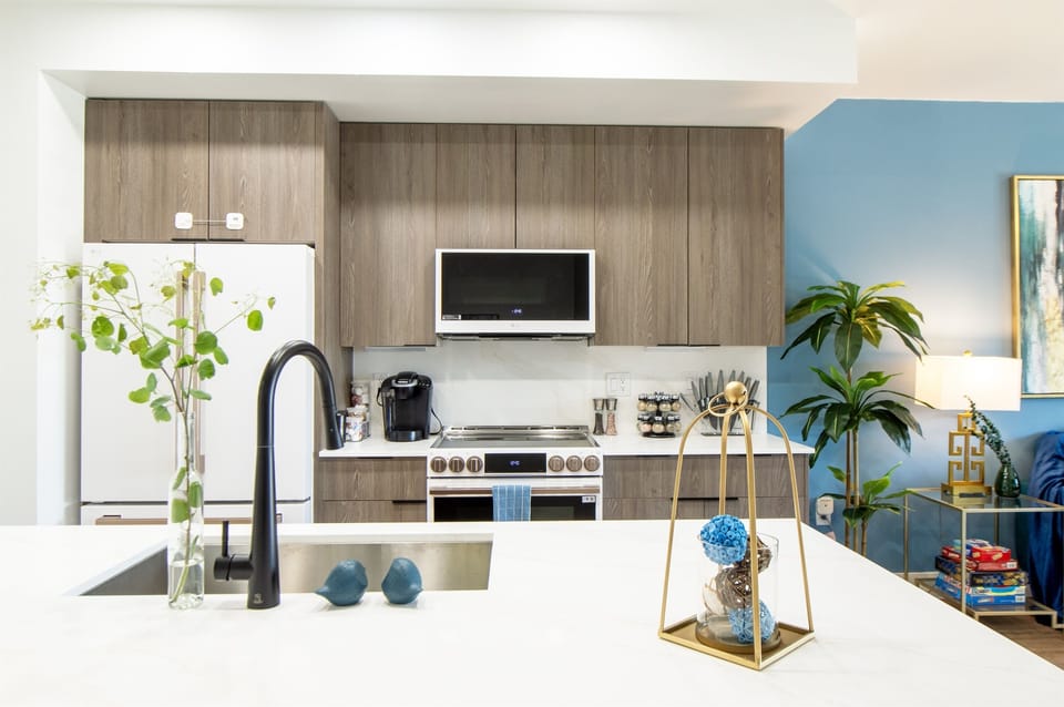 An open and spacious kitchen designed for both style and efficiency, featuring sleek countertops, ample storage, and a seamless layout that makes cooking and gathering a joy.