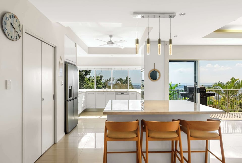 Pull up a seat at the kitchen island, where generous bench space makes morning coffee, casual breakfasts, or sharing a grazing platter feel effortless.