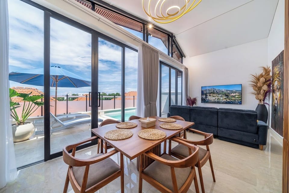 Dining Area: Enjoy meals with stunning pool views under bright natural light!