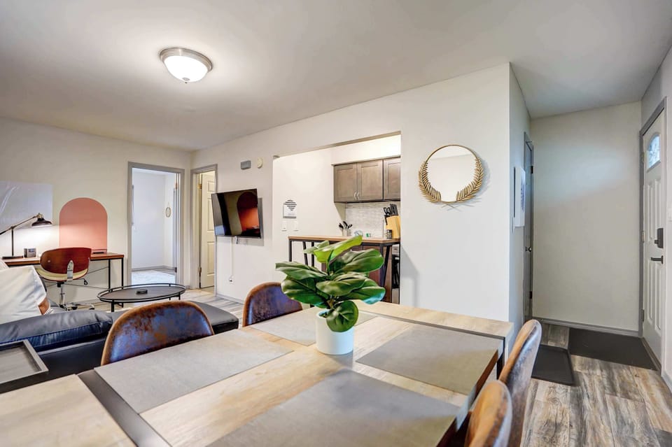 Open-concept layout featuring a welcoming dining area, cozy lounge with sectional seating, and a convenient workspace—offering comfort and function for both relaxation and productivity.