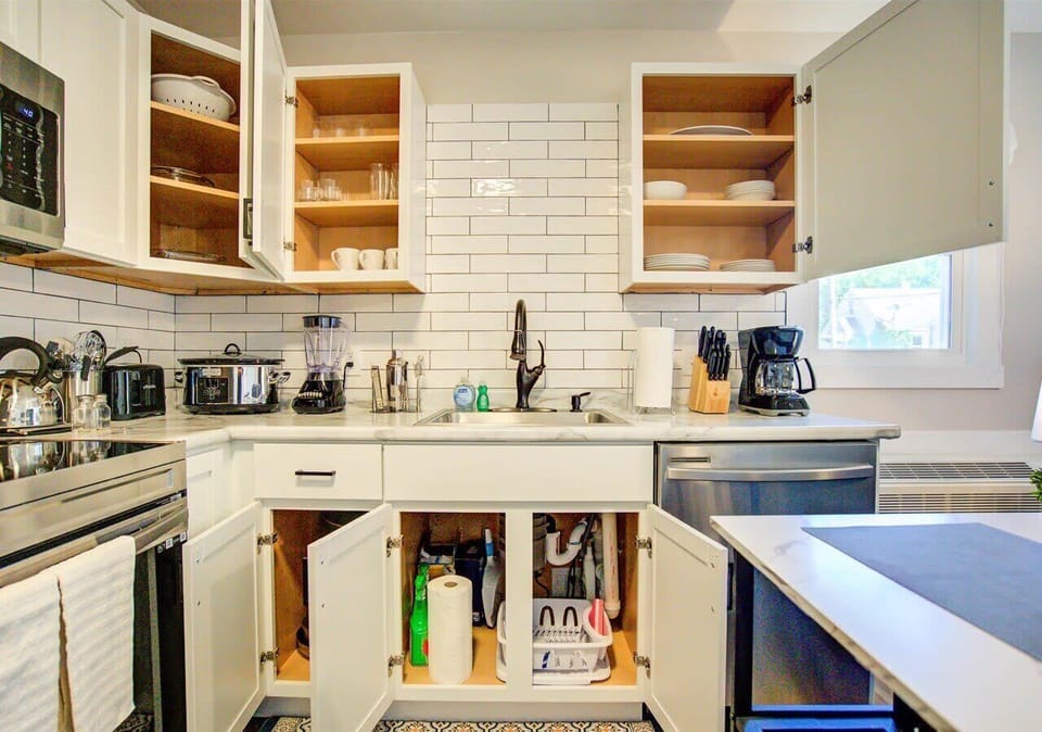 Fully stocked kitchen with open shelving to showcase dinnerware and cookware. Equipped with modern appliances, utensils, and pantry essentials—everything you need for easy meal prep and dining at home.