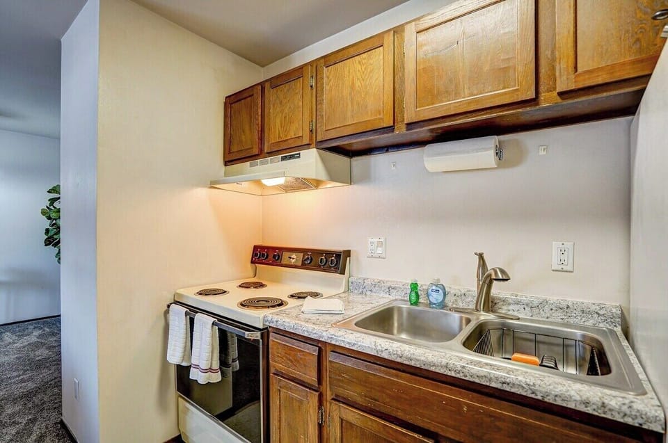 Kitchen is fully stocked with dishes, pots and pans and utensils.