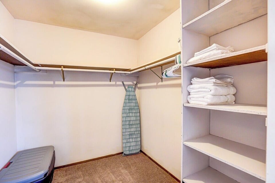 Large walk-in closet with hangers and shelving.