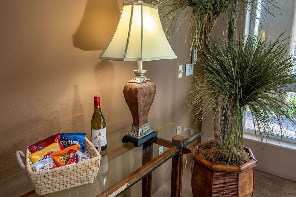 Living room: sectional recliner sofa and 2 accent chairs, 65` smart tv, additional corner seating, natural gas fireplace, wet bar with mini fridge and single sink, 4 bar stools