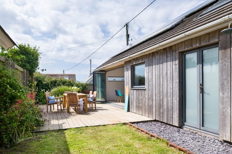 Wooden deck and outdoor furniture at An Mordros Gwithian beach house Cornwall