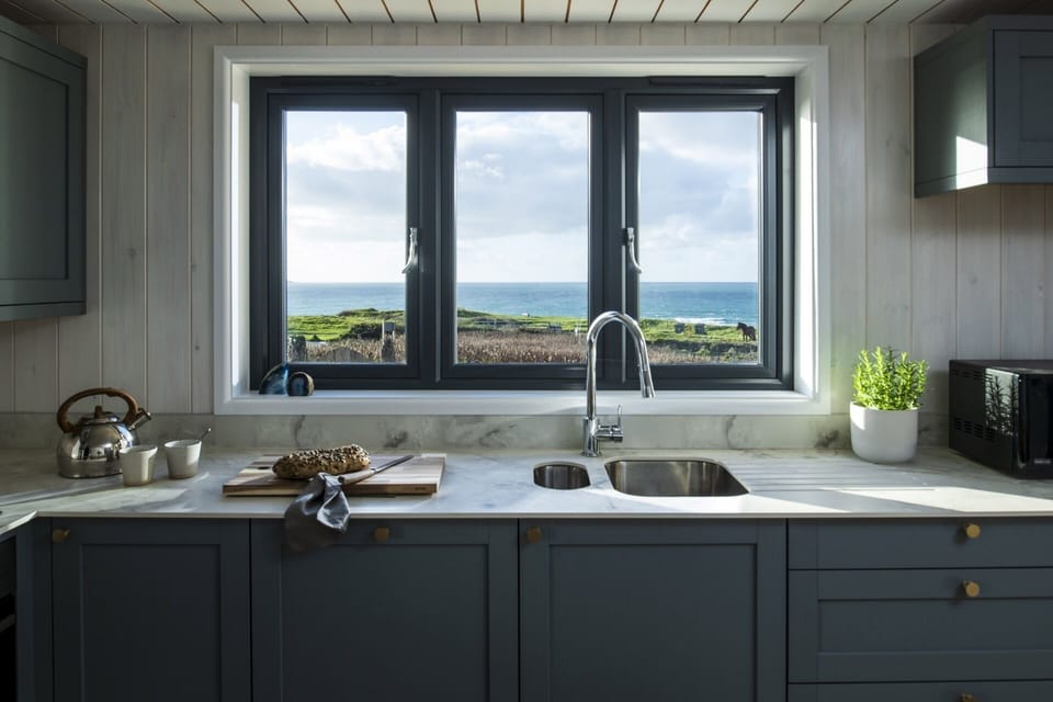 Kitchen with sea views at Blue Haze Gwithian coastal retreat Cornwall