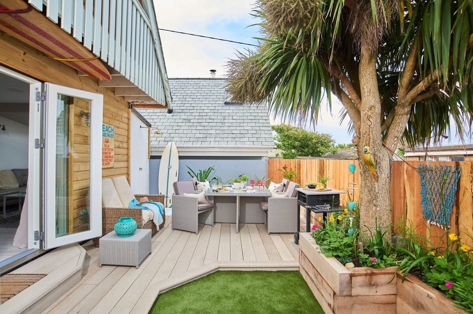 Garden and deck with outdoor furniture at 50 Gwithian Towans beach chalet Gwithian