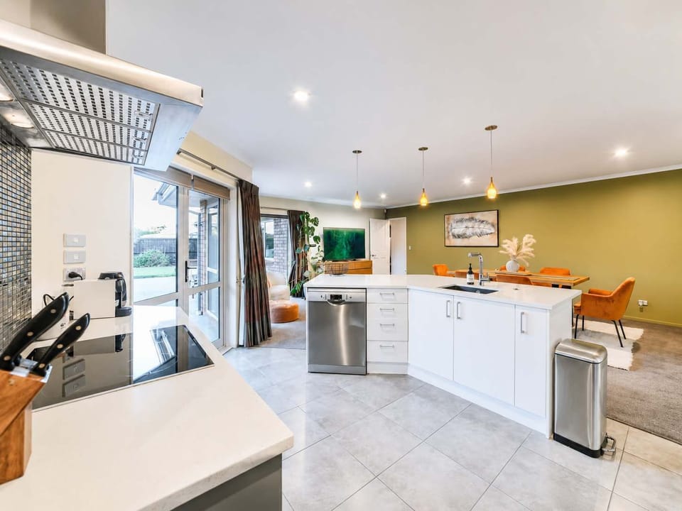 Well-equipped open-plan kitchen with a generous island, extensive bench space, storage and direct access to the courtyard.