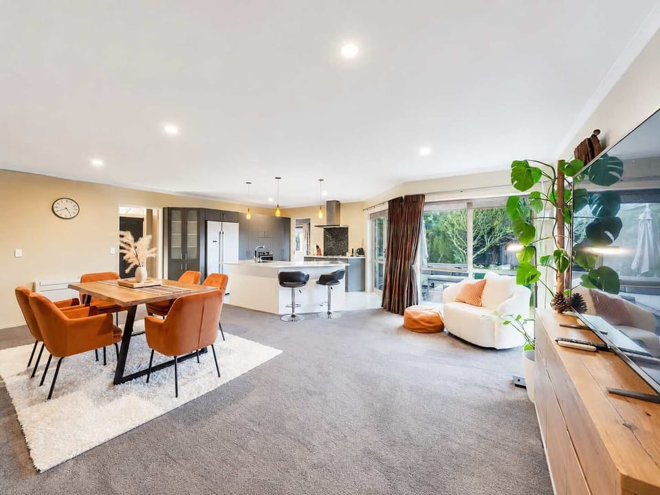 Welcoming open-plan dining and living space with seating for six, comfortable lounge furniture and excellent natural light.