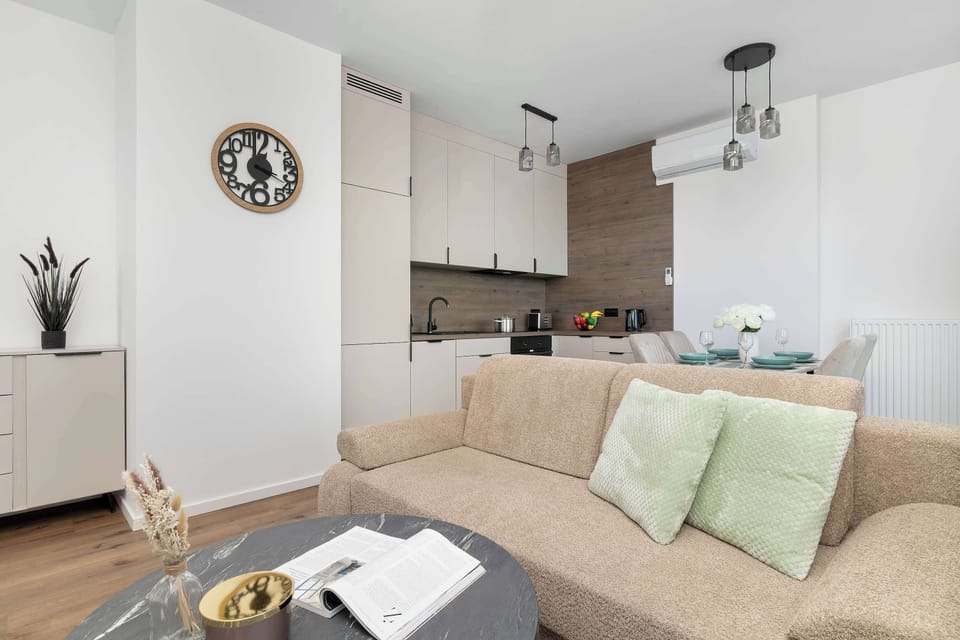 Open-plan living room with a comfortable sofa, dining area, and modern décor.