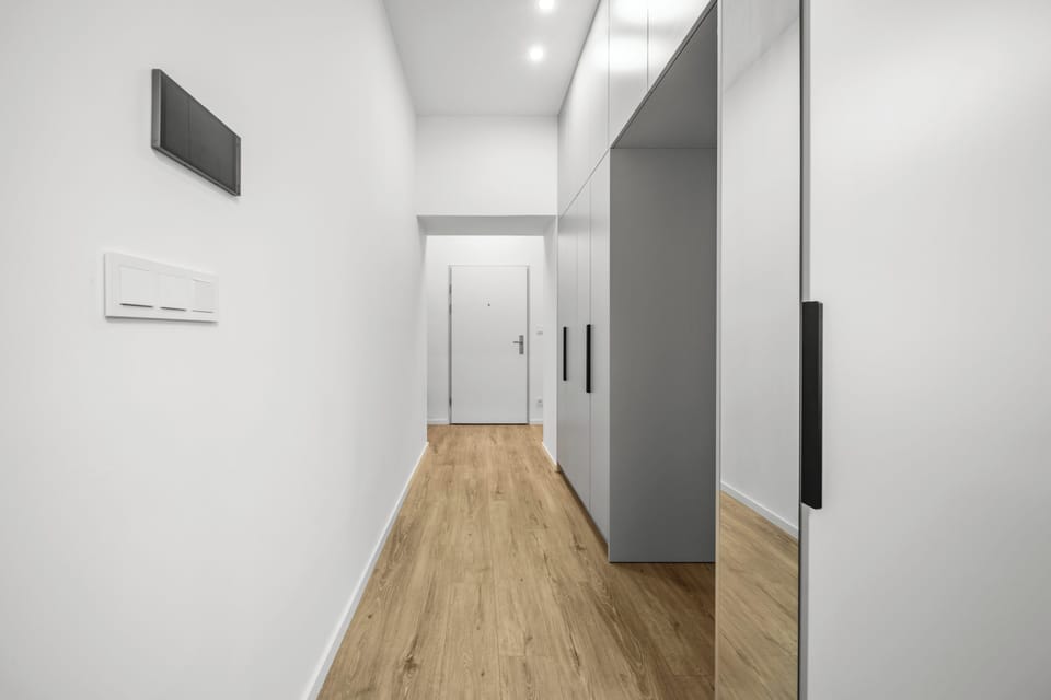 Bright modern entry hall with mirrored wardrobe and ample storage