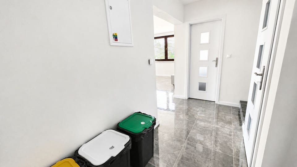 Bright modern entryway with sleek tile floors and a clean, airy feel