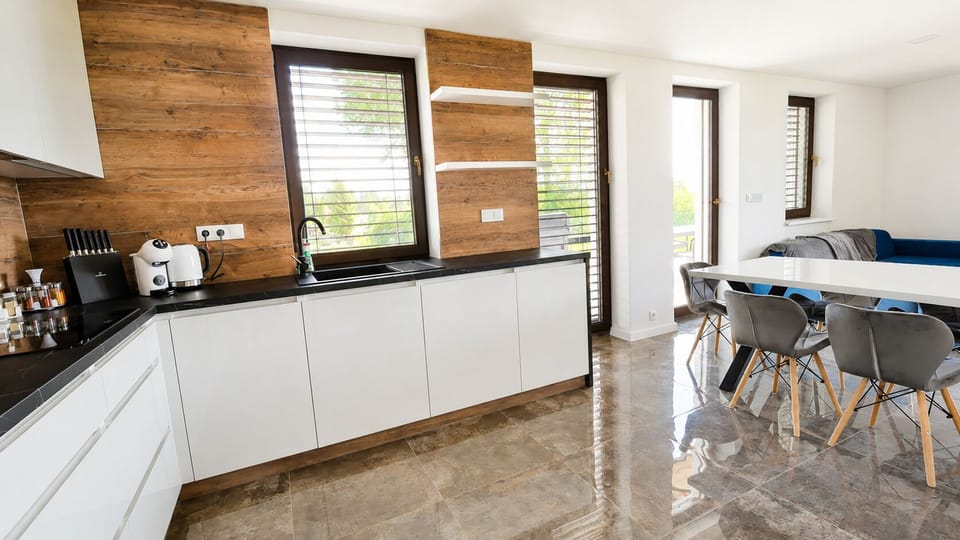 Bright modern kitchen with stylish dining area and abundant natural light