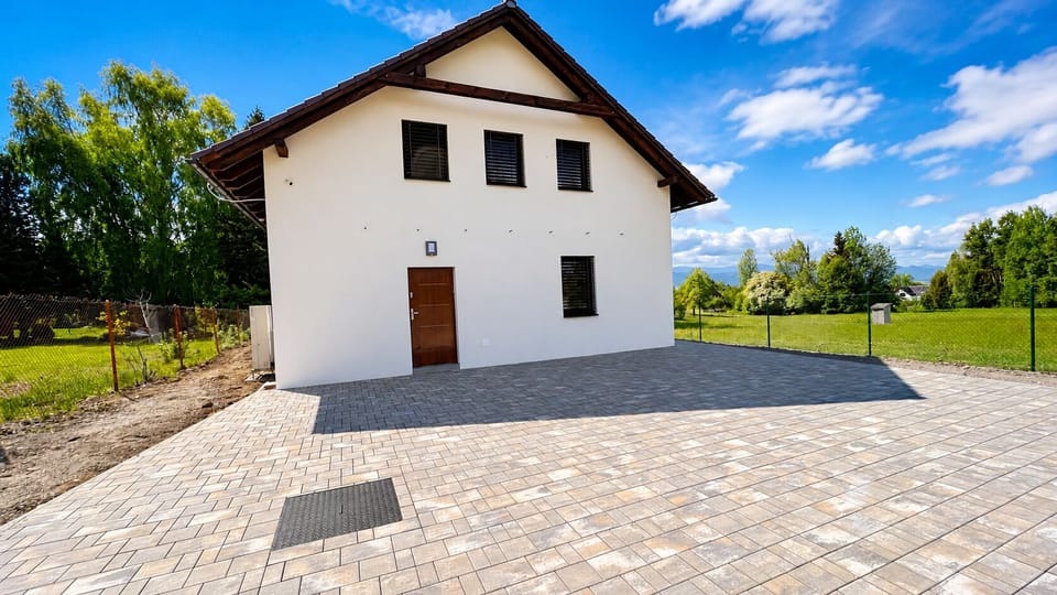 Spacious paved courtyard with peaceful green views