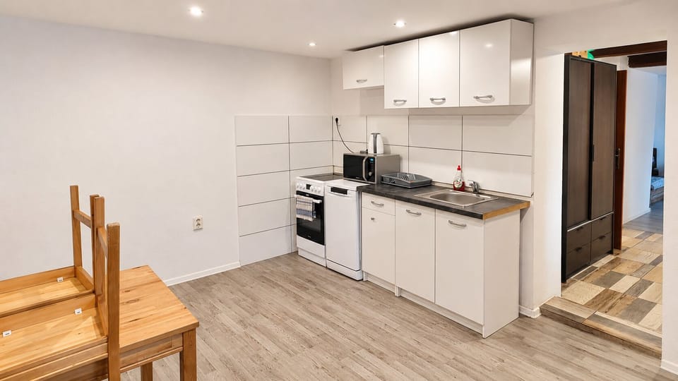 Bright kitchenette with dining space and essential cooking amenities