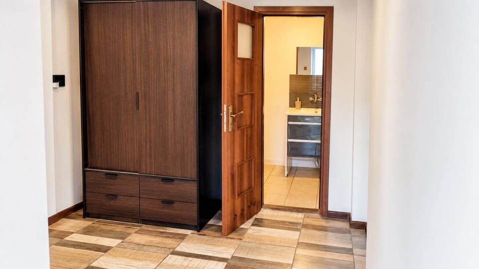 Spacious wardrobe area with easy access to a modern bathroom