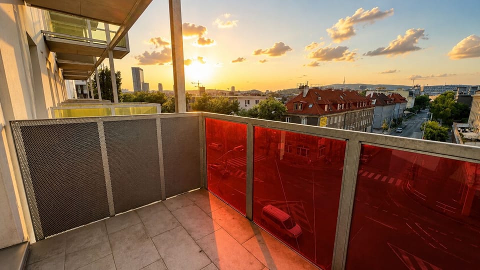 Private sunset-view balcony with warm city skyline vistas