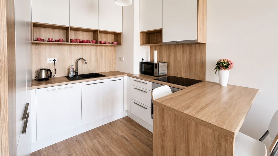 Bright modern kitchenette with breakfast bar and sleek wood finishes