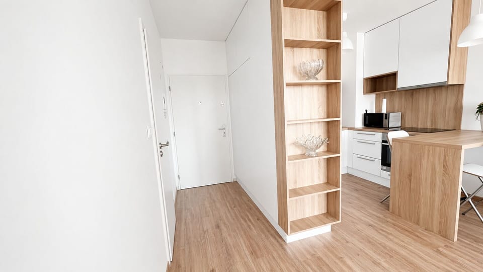 Bright modern entry with stylish wood accents and breakfast bar