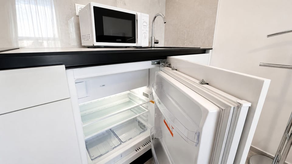 Compact modern kitchenette with mini fridge and microwave
