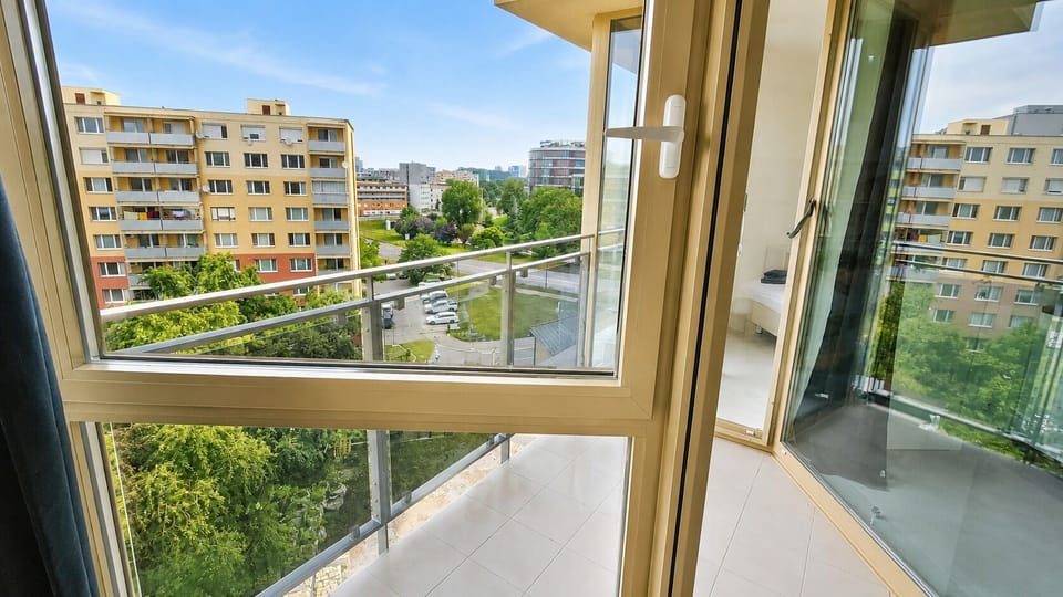 Bright private balcony with open city views and abundant natural light