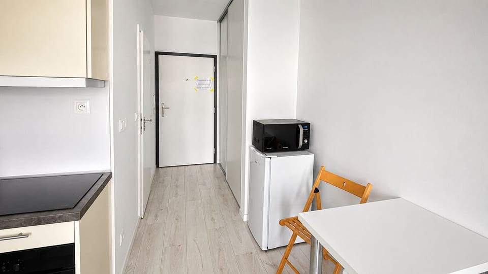 Bright kitchenette with dining nook, mini fridge, and microwave