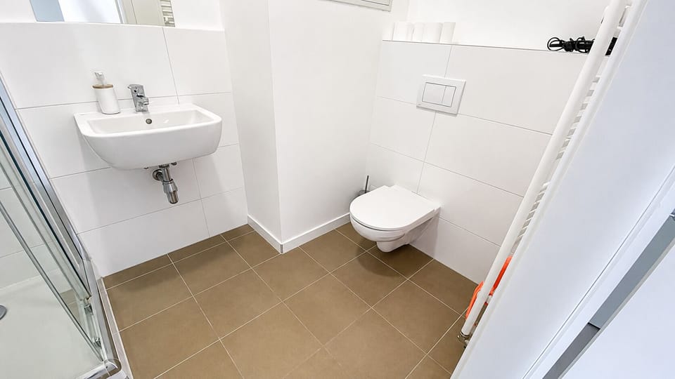 Bright modern bathroom with sleek fixtures and glass-enclosed shower