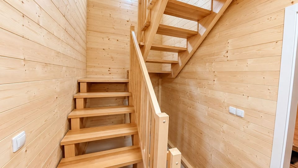 Warm wood staircase with cozy cabin charm and modern open design