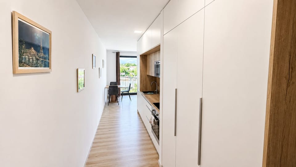 Bright modern kitchenette with dining nook and scenic window views