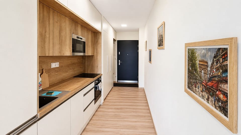 Bright entry hall with sleek kitchenette and warm modern finishes