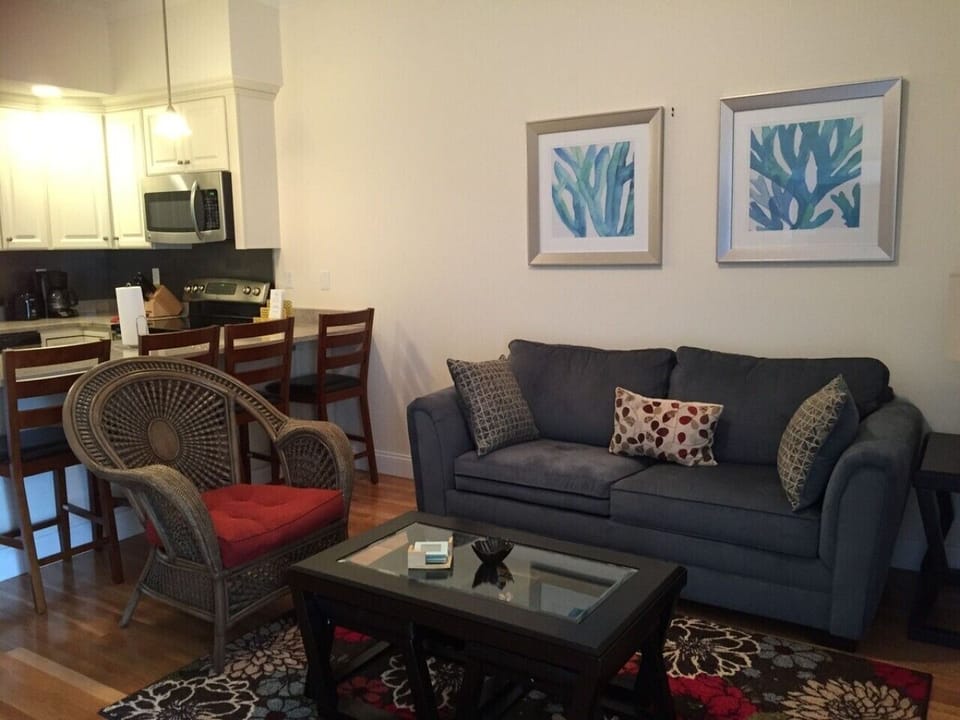 Open living area with a comfy sofa, coffee table and kitchen just steps away.