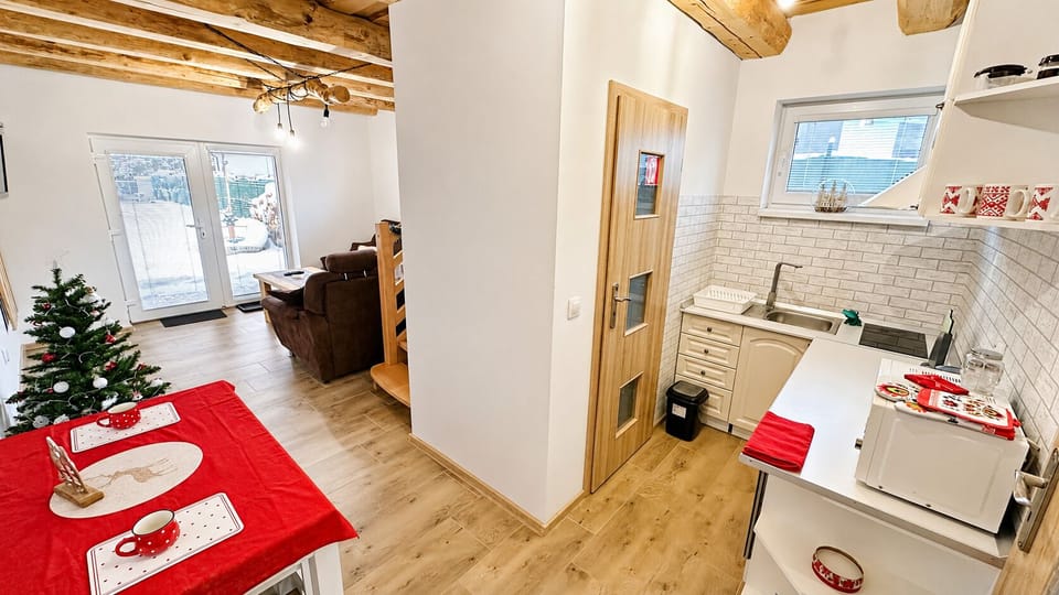 Bright rustic open-plan kitchen and lounge with garden doors