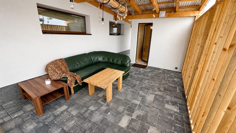 Covered patio with cozy sectional seating and rustic wood accents